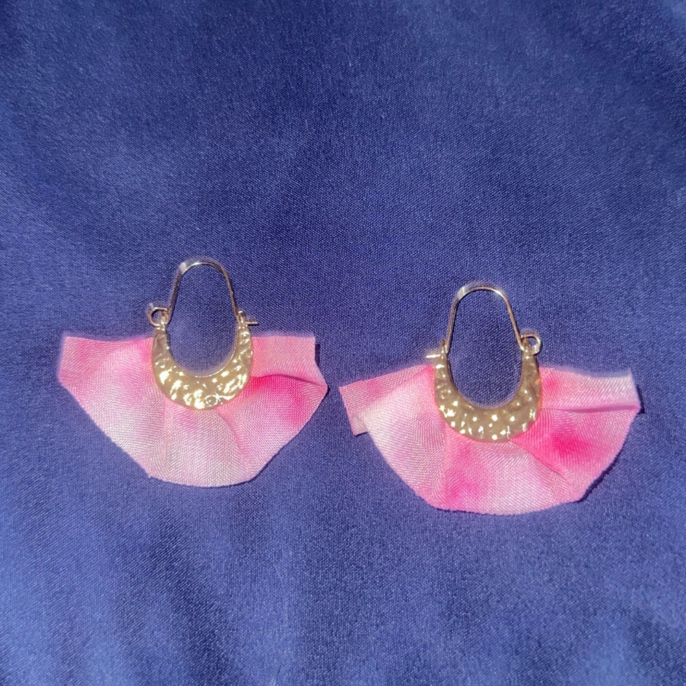 Gold colored hoop earrings with pink and white fabric embellishment